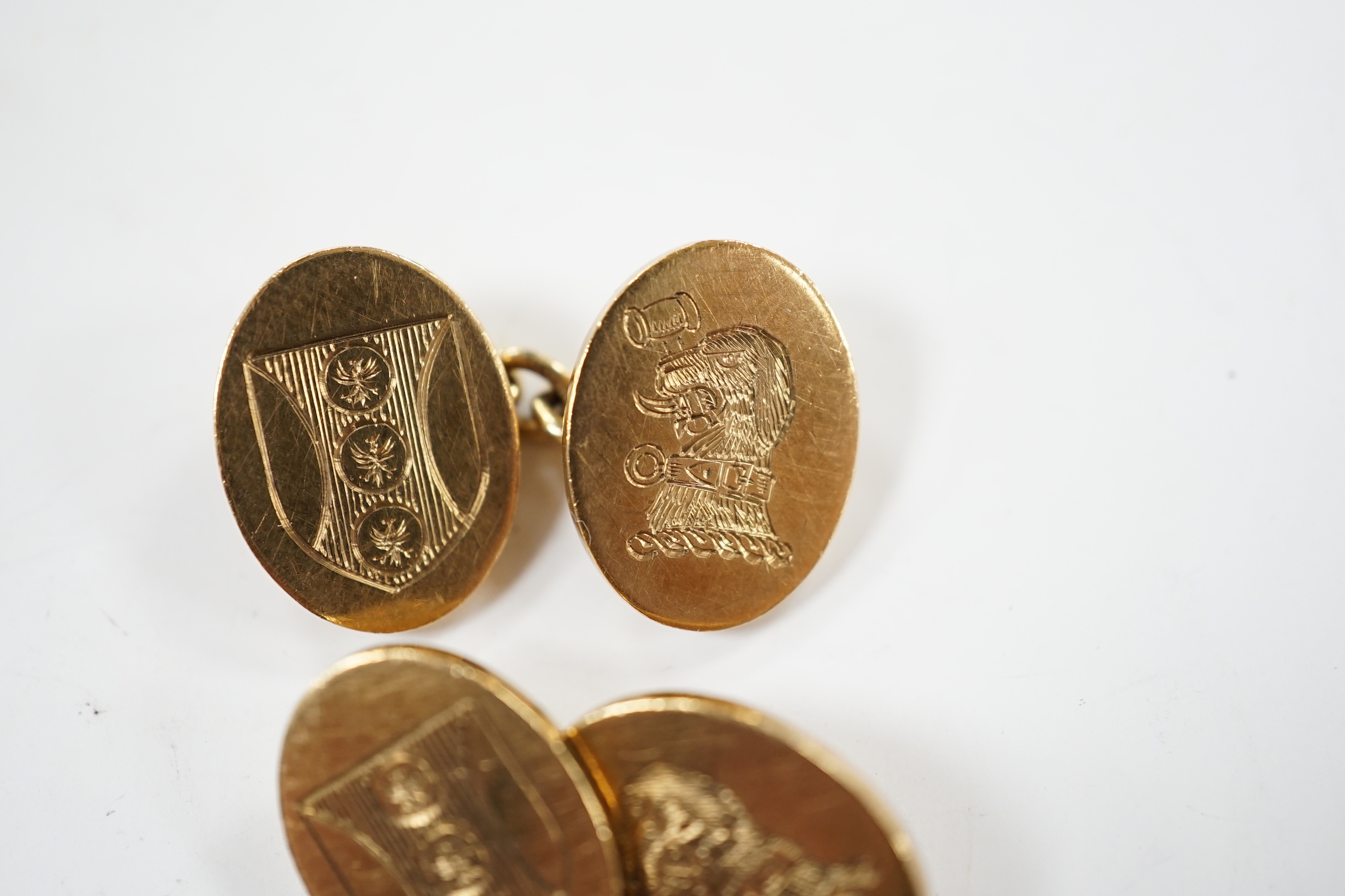 A pair of early 1960's 9ct gold oval cufflinks, with engraved crest and monogram, 10.3 grams.
